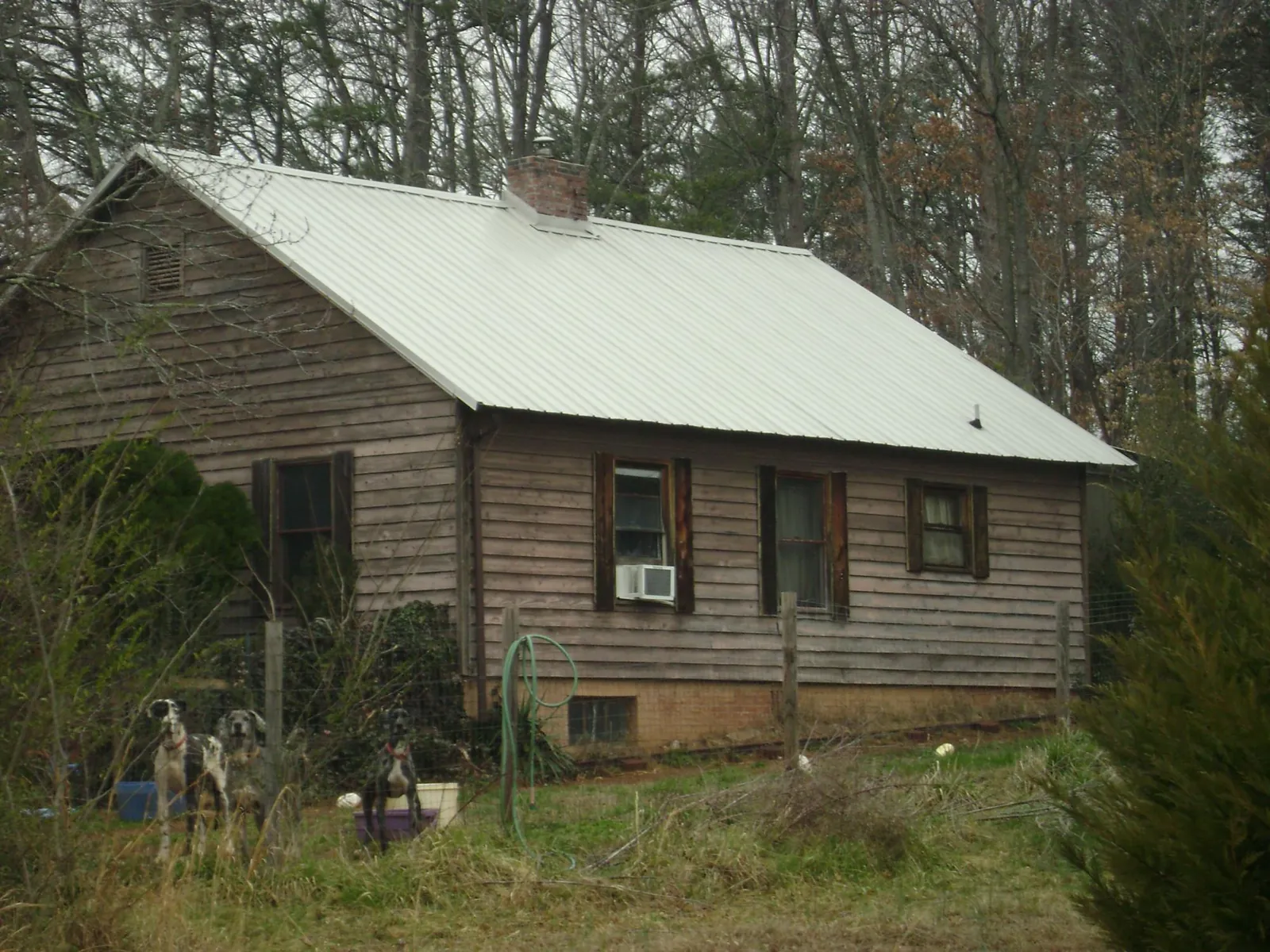 White metal roof on an old wood sided farmhouse, from a Asphalt Shingle Roof Repair job in Wellford